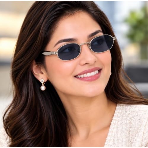 Woman wearing silver-tone oval sunglasses outdoors